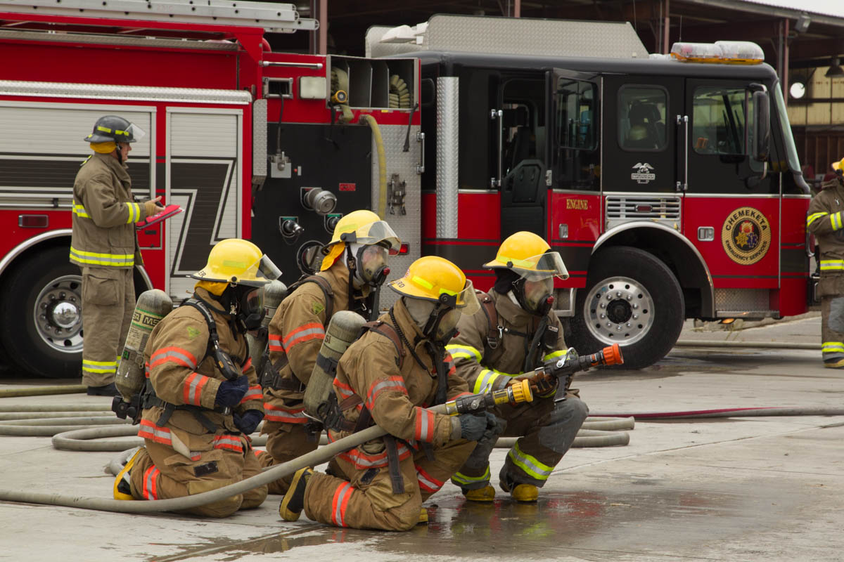 Fire fighters preparing fire hose